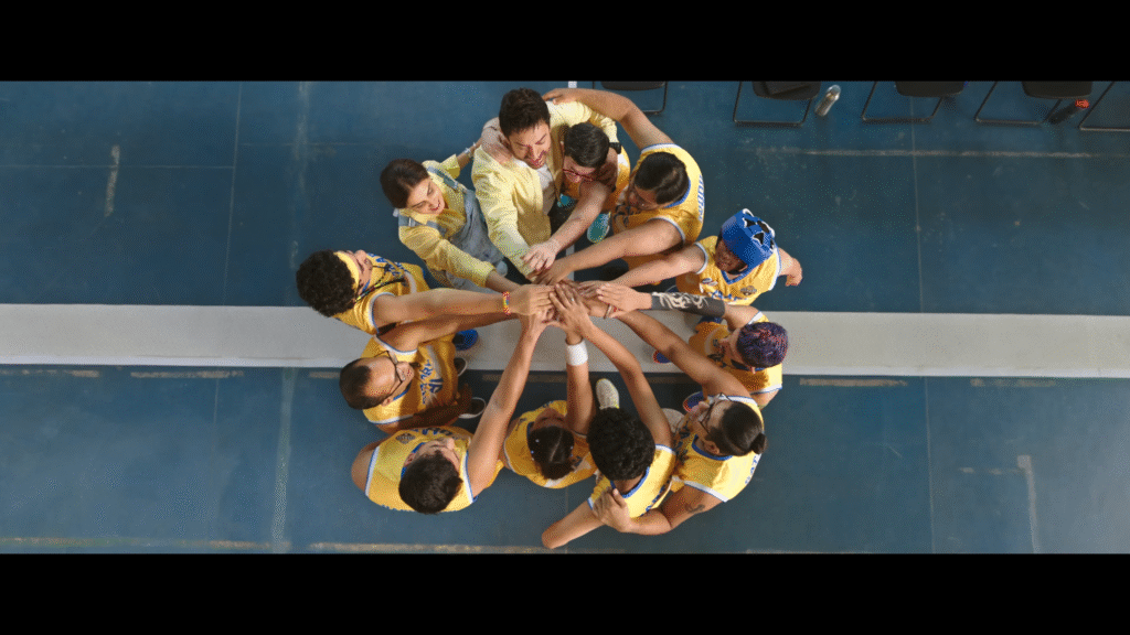 Aamir Khan comforting a young boy in a school art room scene from Sitaare Zameen Par.