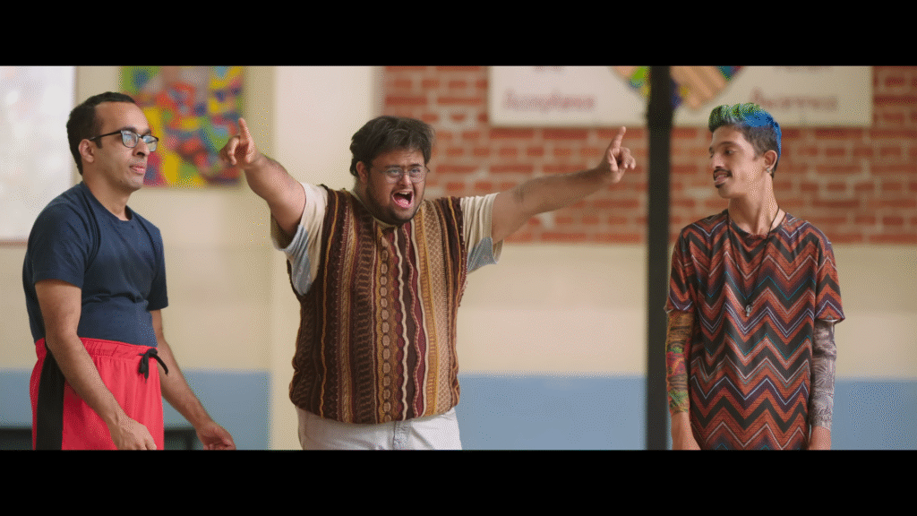 Aamir Khan comforting a young boy in a school art room scene from Sitaare Zameen Par.